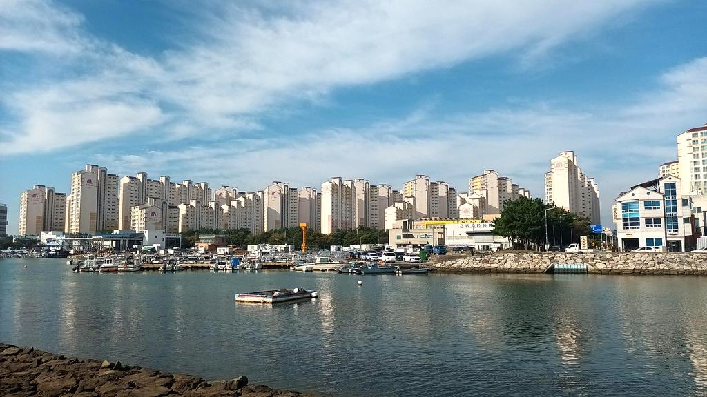 Coastal town harbor with colorful boats and blue skies