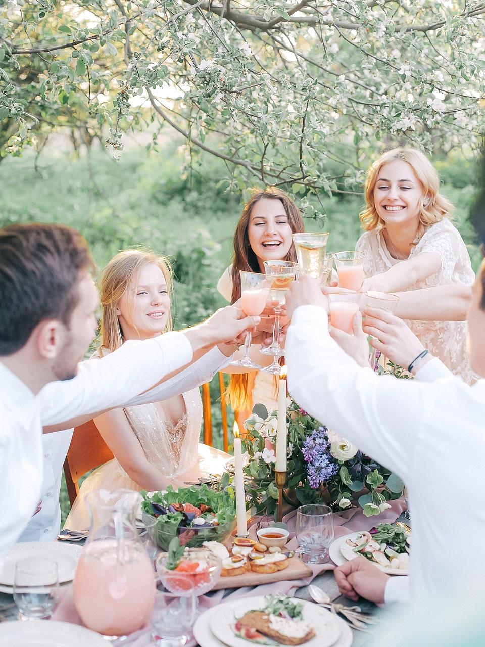Traveler using laptop and phone surrounded by travel brochures